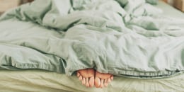 woman feet on the bed
